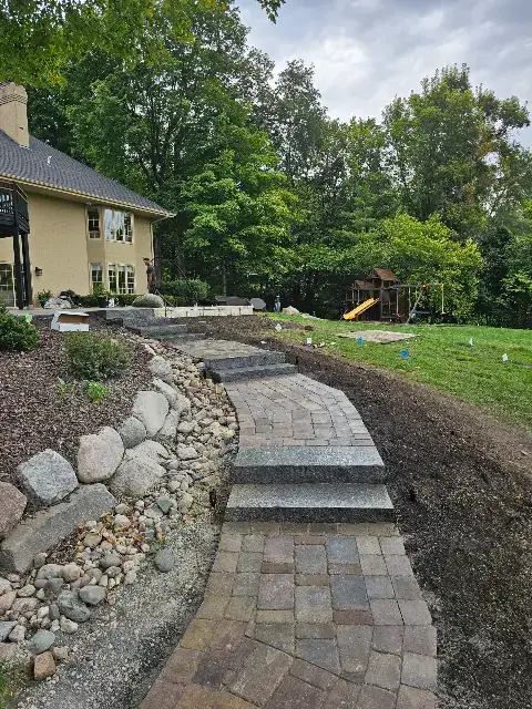 Curved stone walkway leading to a backyard in Waconia
